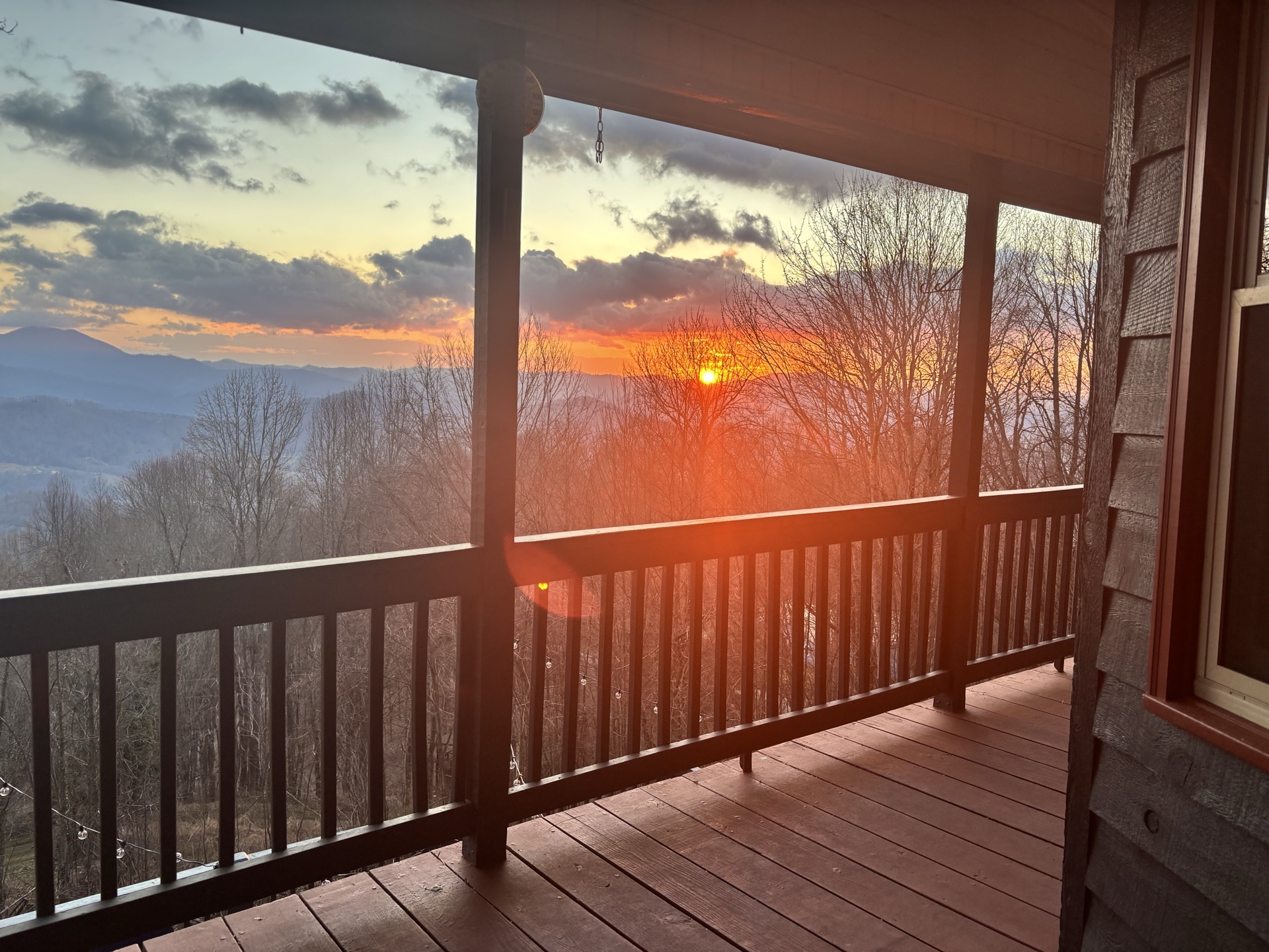 Sunset through the covered porch railing