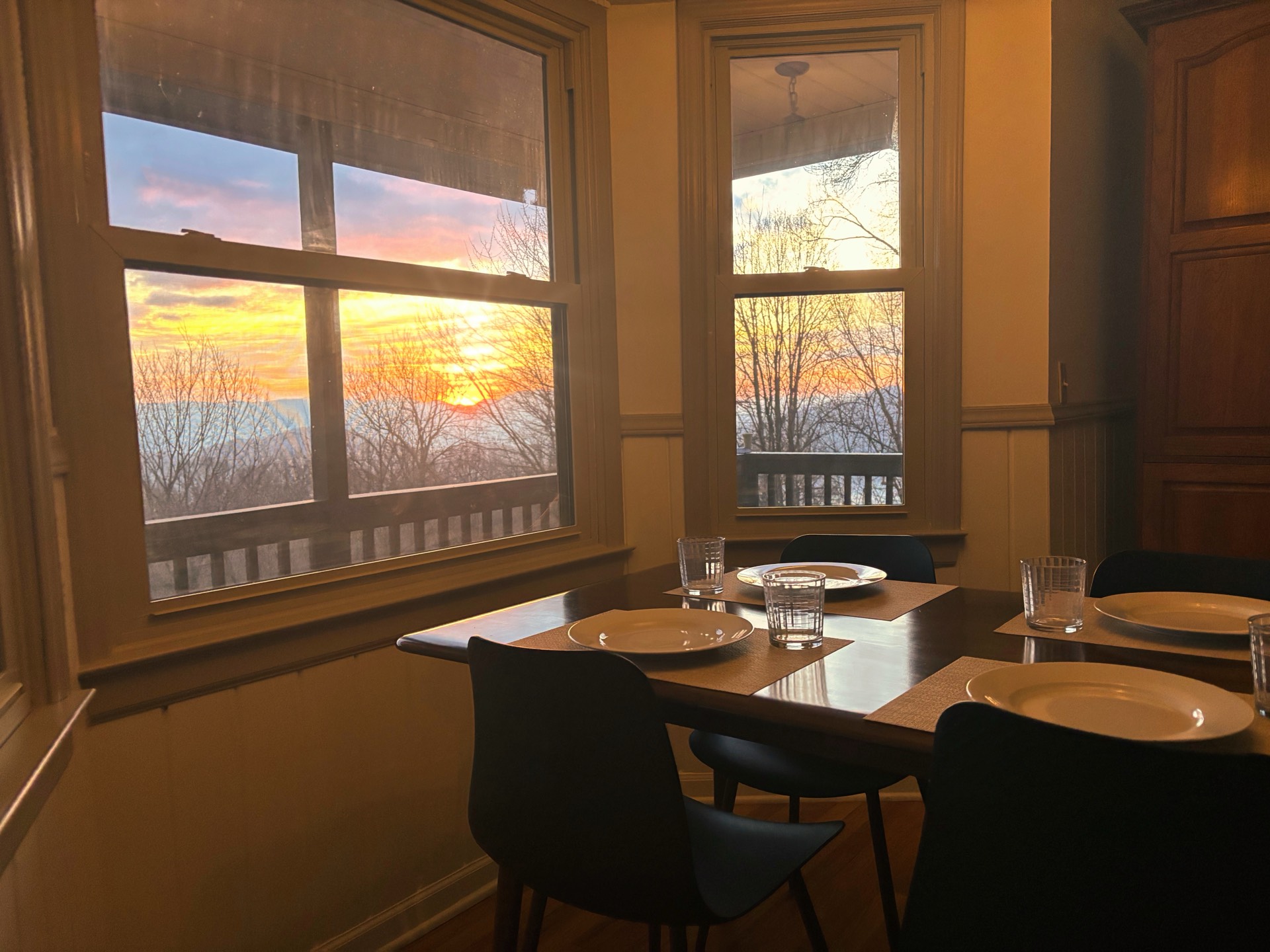 Dining nook with stunning sunset through windows