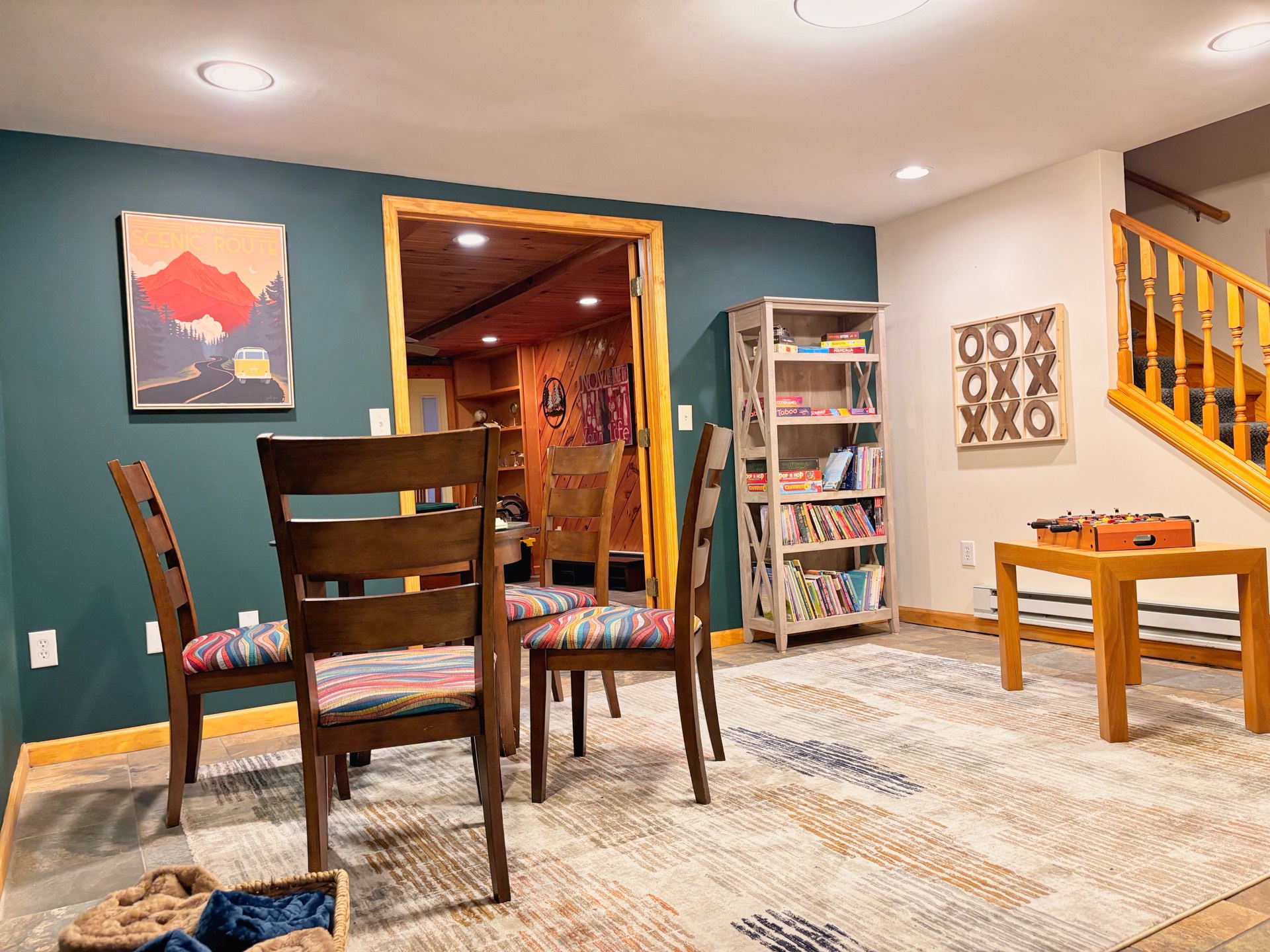 Recreation room wide view with staircase and games